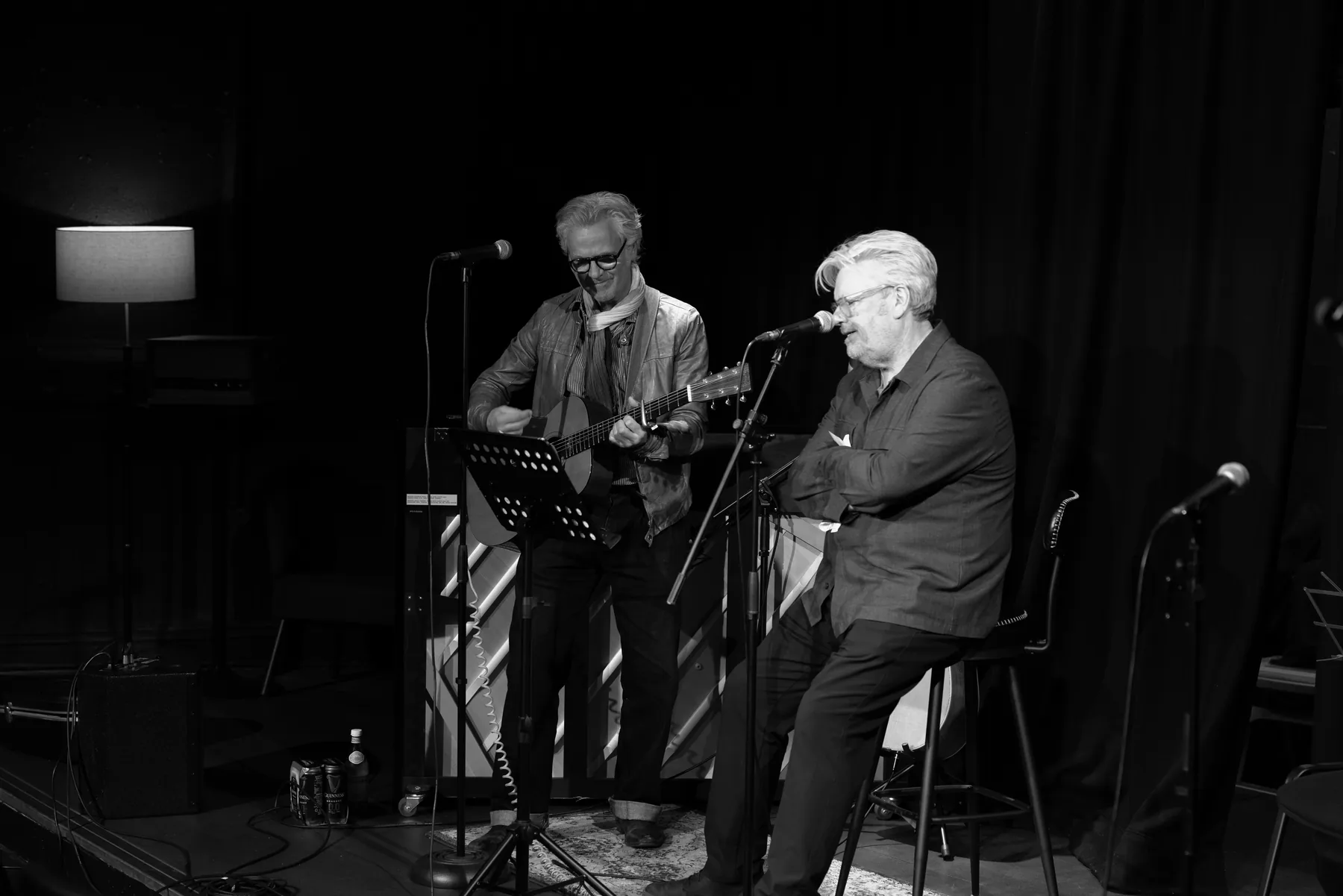 Two performers on the Circle & Star stage, one seated at the microphone