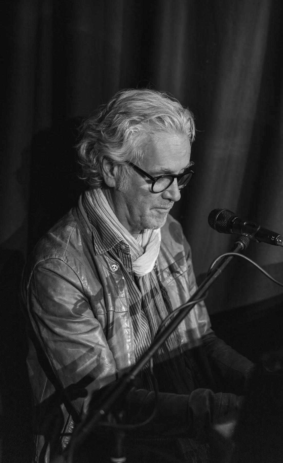 A performer at the keys, close to the microphone
